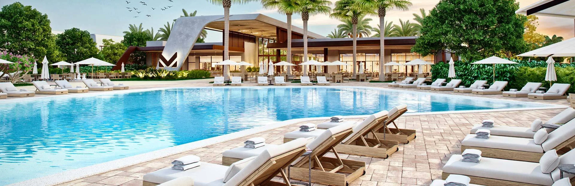 Piscina aquecida e clubhouse do Magic Village by Pininfarina ao entardecer